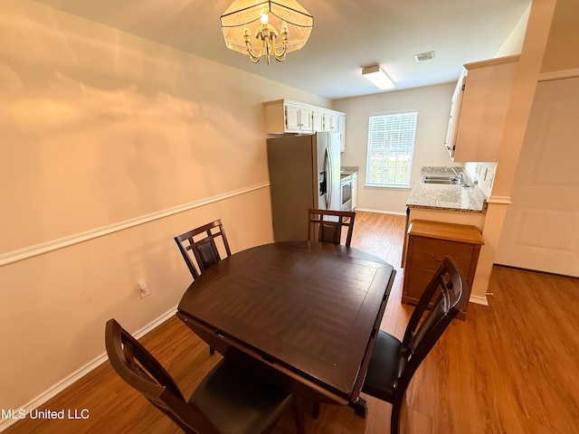 999 Hamakua St, Diamondhead, MS 39525 - dining space featuring wood finished floors and a chandelier