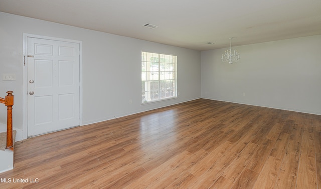 828 Briarwood Dr, Jackson, MS 39211 - empty room featuring a chandelier, light wood-type flooring, and baseboards