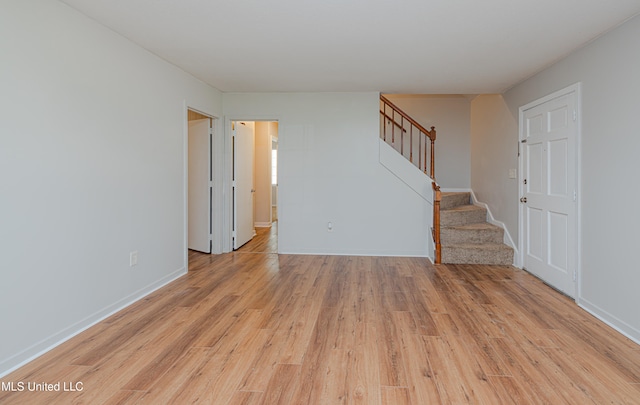 828 Briarwood Dr, Jackson, MS 39211 - unfurnished room with stairway, light wood-type flooring, and baseboards