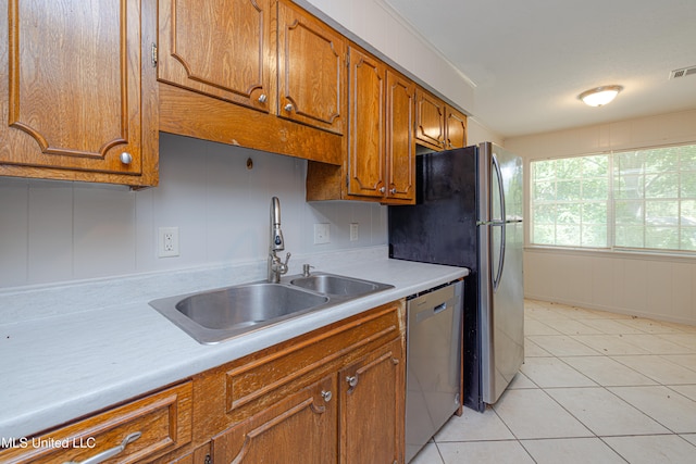 828 Briarwood Dr, Jackson, MS 39211 - kitchen featuring a sink, dishwasher, brown cabinetry, and light countertops