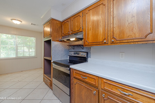 828 Briarwood Dr, Jackson, MS 39211 - kitchen featuring electric stove, under cabinet range hood, brown cabinetry, light countertops, and light tile patterned floors