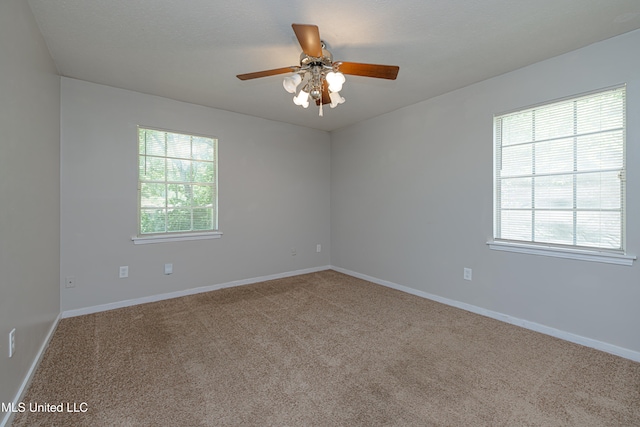 828 Briarwood Dr, Jackson, MS 39211 - spare room featuring carpet floors, a ceiling fan, and baseboards