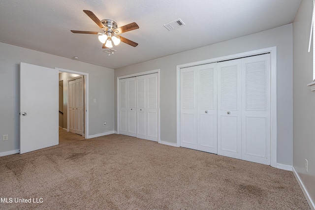 828 Briarwood Dr, Jackson, MS 39211 - unfurnished bedroom featuring carpet flooring, multiple closets, baseboards, and a ceiling fan