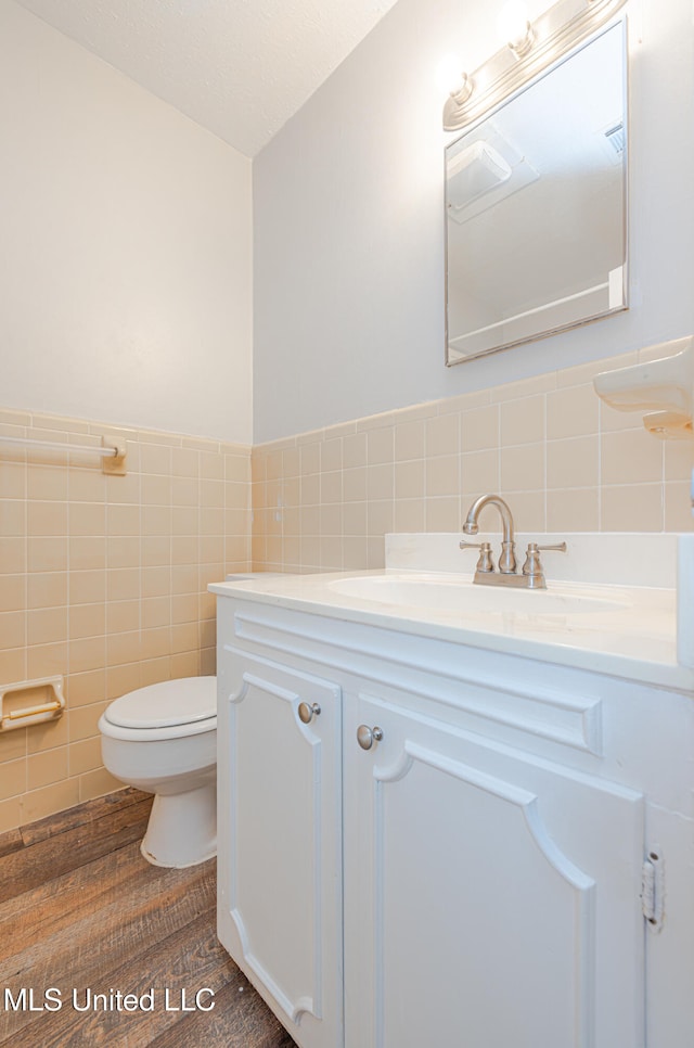 828 Briarwood Dr, Jackson, MS 39211 - half bath with tile walls, vanity, toilet, and wainscoting