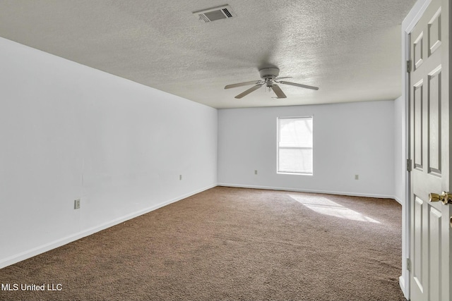 carpeted spare room with a textured ceiling and ceiling fan