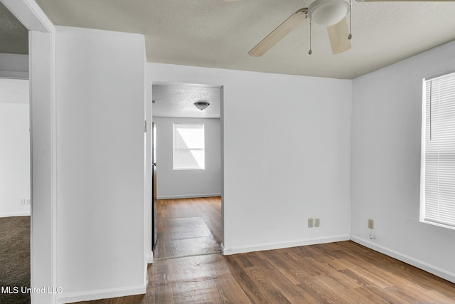 spare room with ceiling fan, hardwood / wood-style flooring, and a textured ceiling