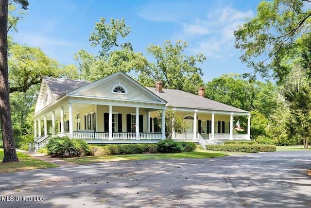 neoclassical home featuring a porch