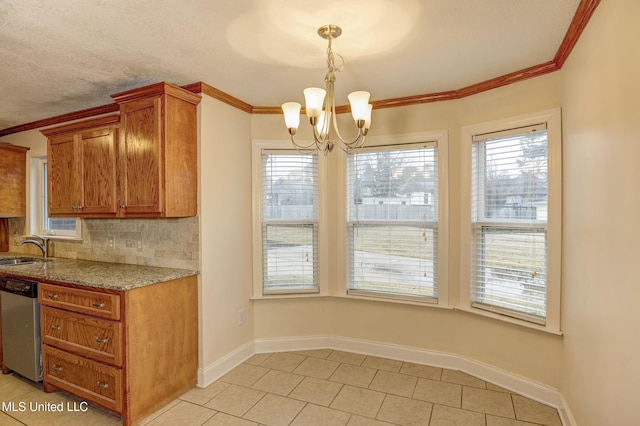 kitchen with dishwasher, sink, backsplash, hanging light fixtures, and ornamental molding