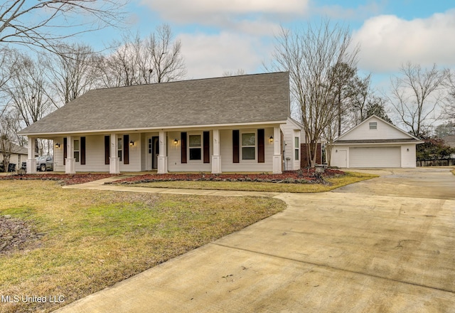 view of front of house with a porch, a garage, an outdoor structure, and a front lawn