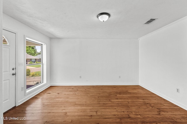 1914 Twin Pine Dr, Pearl, MS 39208 - spare room featuring hardwood / wood-style flooring, a textured ceiling, baseboards, and ornamental molding