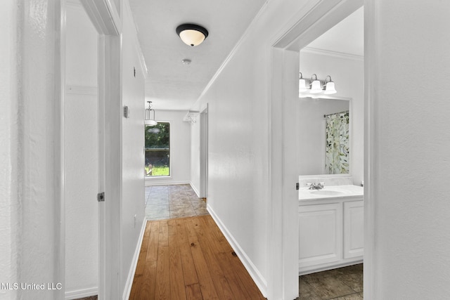 1914 Twin Pine Dr, Pearl, MS 39208 - hall with a sink, ornamental molding, wood-type flooring, and baseboards