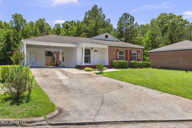 1914 Twin Pine Dr, Pearl, MS 39208 - ranch-style house with a front yard, driveway, brick siding, and a carport
