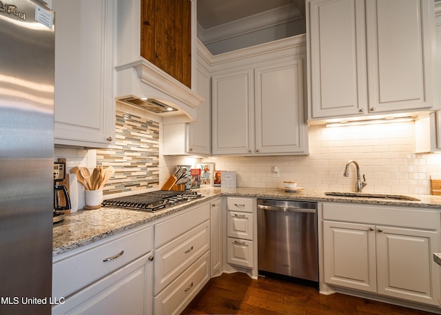 kitchen featuring backsplash, stainless steel appliances, and white cabinetry