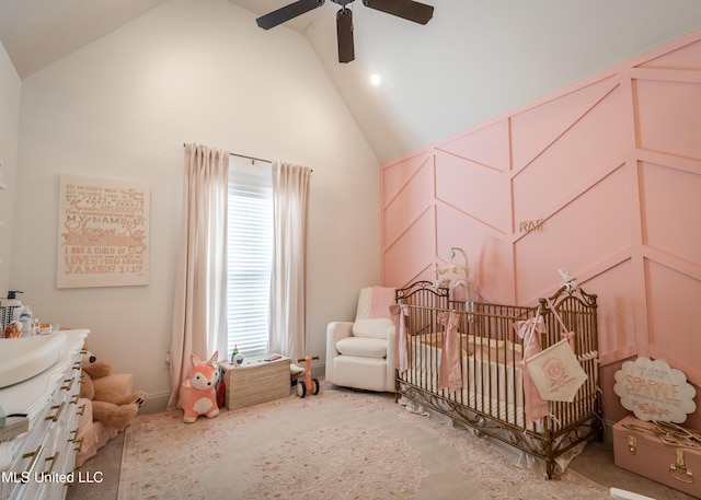 bedroom featuring a crib, carpet flooring, high vaulted ceiling, and ceiling fan