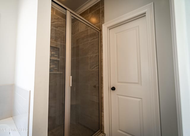 bathroom featuring shower with separate bathtub