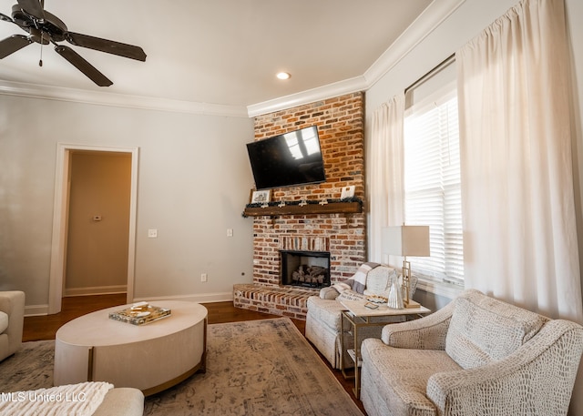 living room featuring a fireplace, crown molding, plenty of natural light, and wood-type flooring