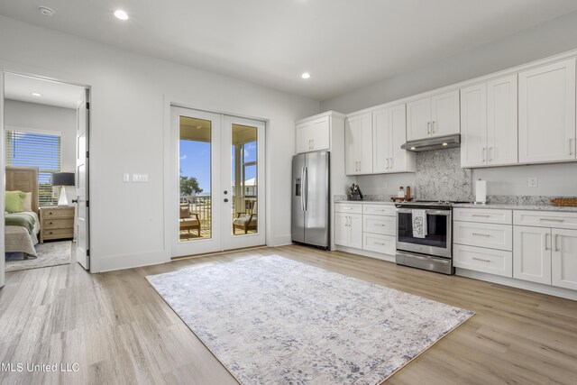 124 Arkansas Ave, Gulfport, MS 39507 - kitchen featuring white cabinets, appliances with stainless steel finishes, french doors, light wood-style flooring, and under cabinet range hood
