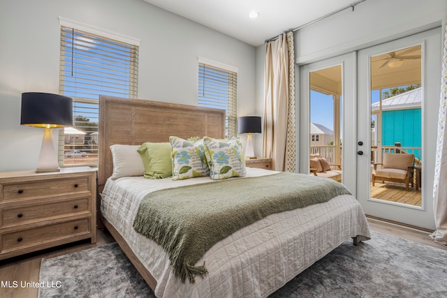 bedroom featuring access to outside, dark hardwood / wood-style floors, and french doors