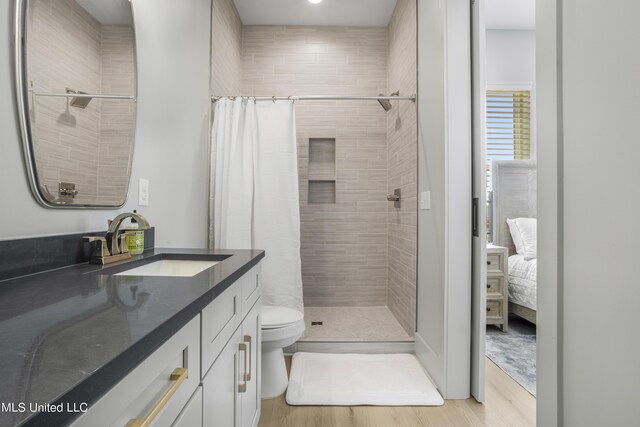 124 Arkansas Ave, Gulfport, MS 39507 - full bath featuring vanity, wood finished floors, a tile shower, and toilet