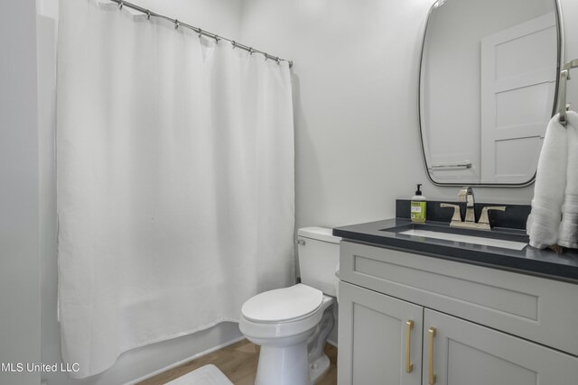 124 Arkansas Ave, Gulfport, MS 39507 - bathroom featuring toilet, wood finished floors, and vanity