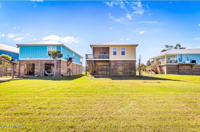 rear view of house with a yard