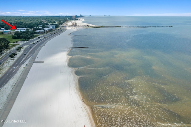 bird's eye view with a water view and a beach view