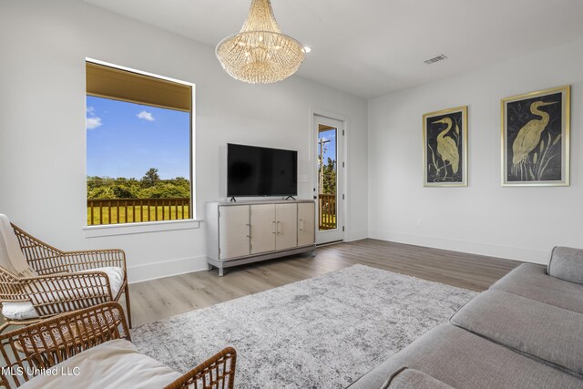 124 Arkansas Ave, Gulfport, MS 39507 - living area featuring baseboards, visible vents, wood finished floors, and a notable chandelier