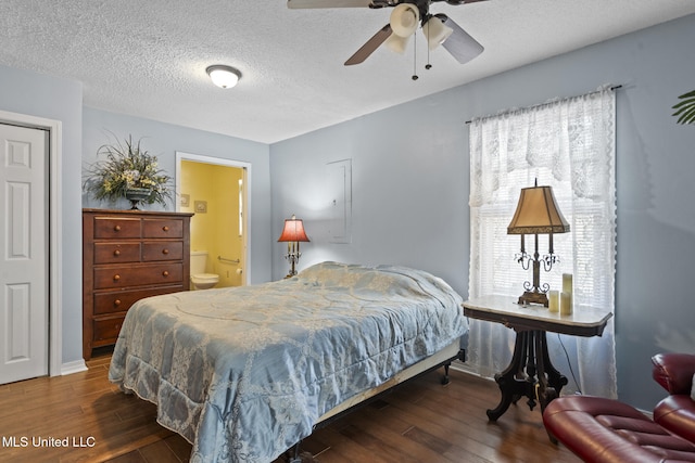 bedroom with a textured ceiling, ensuite bath, and wood finished floors