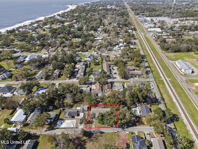 bird's eye view with a view of the beach, a water view, and a residential view