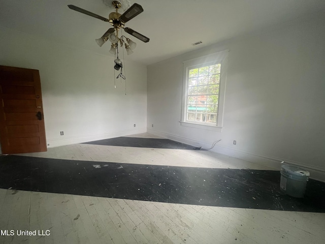 spare room featuring hardwood / wood-style floors and ceiling fan