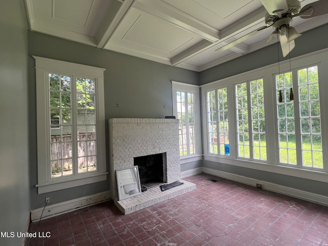 unfurnished sunroom featuring beamed ceiling, a fireplace, and ceiling fan