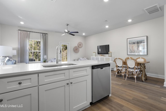 12278 Frazier Ln, Gulfport, MS 39503 - kitchen featuring dishwasher, a sink, light countertops, dark wood-type flooring, and recessed lighting