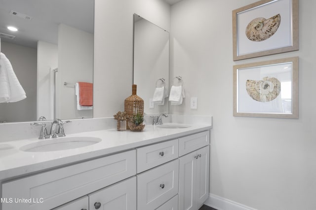 12278 Frazier Ln, Gulfport, MS 39503 - full bathroom with double vanity and baseboards