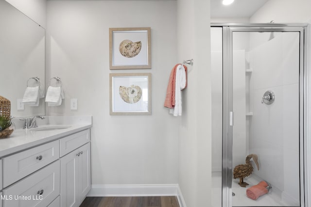 12278 Frazier Ln, Gulfport, MS 39503 - full bath with vanity, a stall shower, baseboards, and wood finished floors