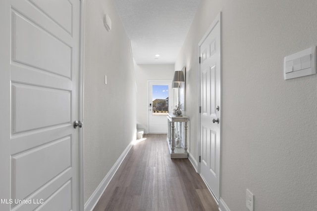 12278 Frazier Ln, Gulfport, MS 39503 - hallway featuring dark wood-type flooring, baseboards, and a textured wall