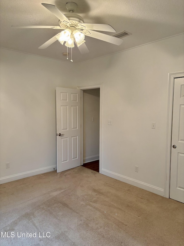 1405 Bay Ridge Dr, Gautier, MS 39553 - empty room with light colored carpet, a ceiling fan, a textured ceiling, and baseboards