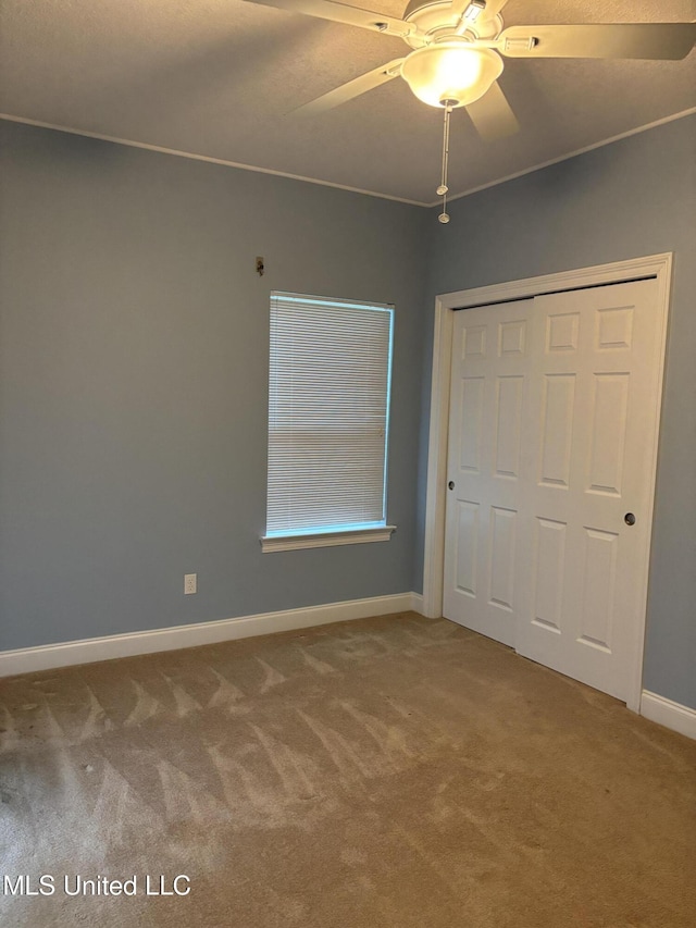1405 Bay Ridge Dr, Gautier, MS 39553 - unfurnished bedroom featuring carpet, baseboards, a closet, and a ceiling fan