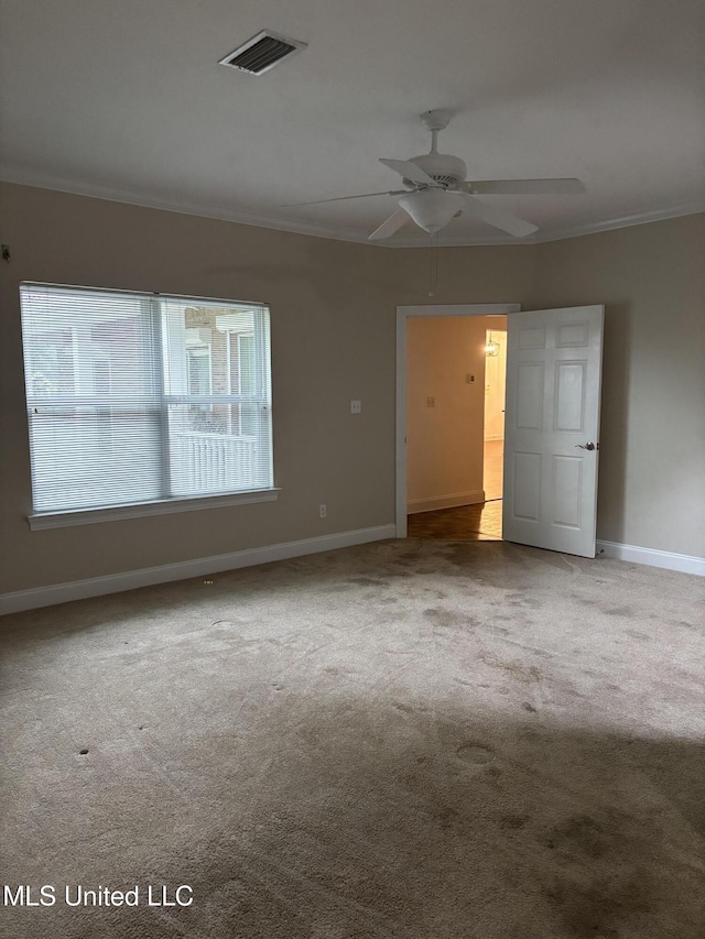 1405 Bay Ridge Dr, Gautier, MS 39553 - carpeted spare room featuring ornamental molding, baseboards, and a ceiling fan