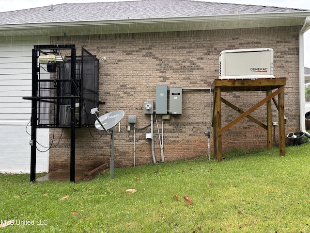 1405 Bay Ridge Dr, Gautier, MS 39553 - view of property exterior with brick siding, a yard, and a shingled roof