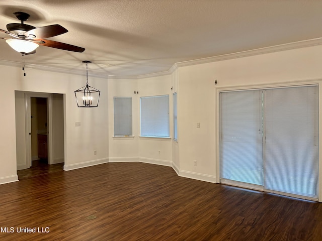 1405 Bay Ridge Dr, Gautier, MS 39553 - unfurnished dining area with a ceiling fan, a chandelier, dark wood-style floors, baseboards, and ornamental molding