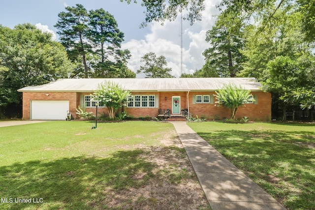 221 S Third St, Wiggins, MS 39577 - single story home with a front yard, a garage, brick siding, and driveway