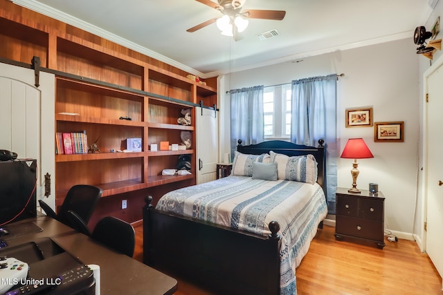 221 S Third St, Wiggins, MS 39577 - bedroom featuring wood finished floors, crown molding, an office area, and a barn door