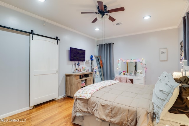 221 S Third St, Wiggins, MS 39577 - bedroom featuring light wood-style floors, crown molding, a barn door, recessed lighting, and ceiling fan