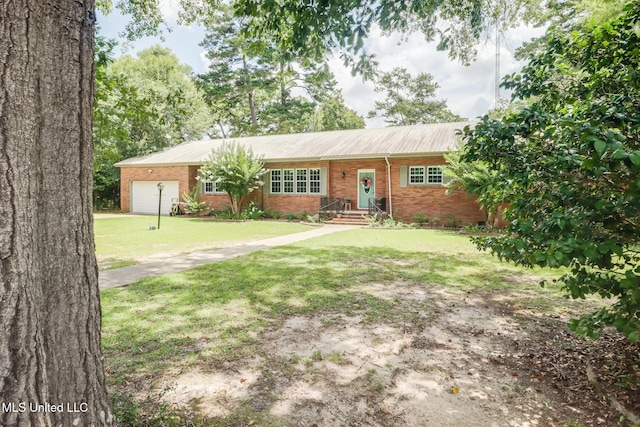 221 S Third St, Wiggins, MS 39577 - ranch-style home with brick siding, an attached garage, and a front yard