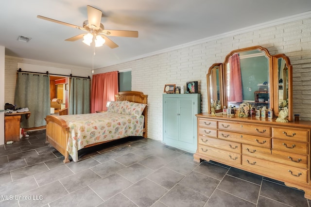 221 S Third St, Wiggins, MS 39577 - bedroom featuring brick wall, ornamental molding, a barn door, a ceiling fan, and dark tile patterned floors