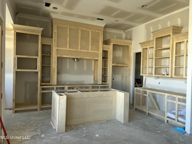 kitchen featuring open shelves and unfinished concrete floors