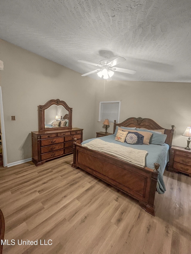 bedroom featuring a textured ceiling and light wood-type flooring