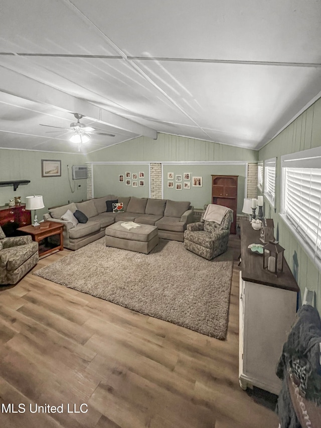 living room with a wall mounted air conditioner, wood-type flooring, vaulted ceiling, and ceiling fan