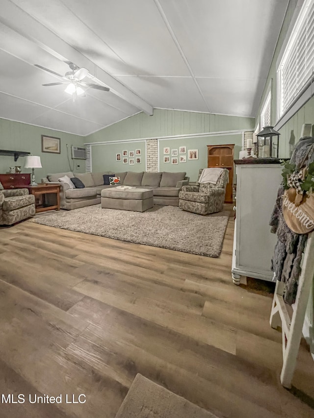 living room featuring hardwood / wood-style floors, lofted ceiling with beams, ceiling fan, and an AC wall unit