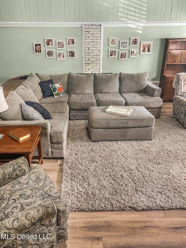 living room with ornamental molding and hardwood / wood-style flooring